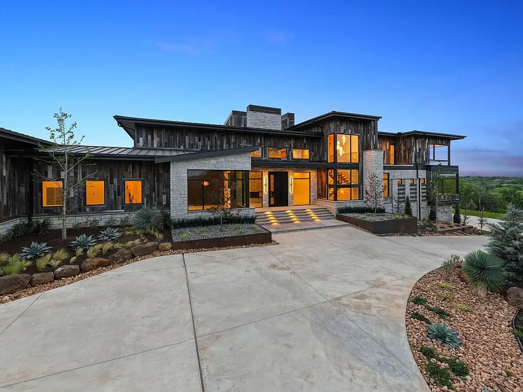 Modern wood and stone Texas home photographed at dusk with no holiday lighting installed