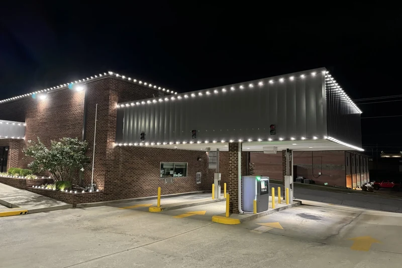 Fuel station canopy and building outlined in crisp warm white lighting along every structural edge
