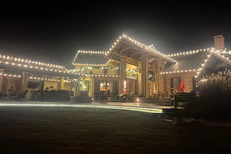 Single storey ranch home with warm white lights along the roofline and across the full length of the front porch